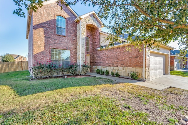 front facade featuring a garage and a front lawn