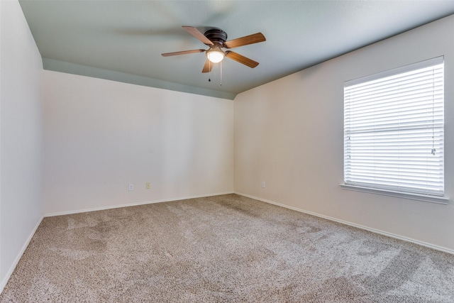 carpeted empty room featuring plenty of natural light and ceiling fan