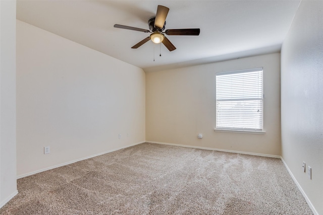 carpeted spare room with ceiling fan