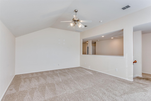 carpeted spare room featuring ceiling fan and lofted ceiling