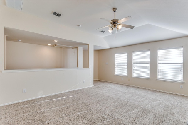 carpeted empty room featuring ceiling fan and lofted ceiling