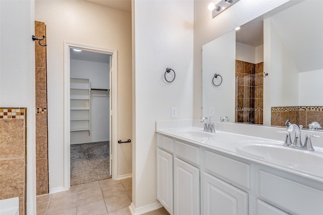 bathroom featuring tile patterned floors, vanity, and walk in shower