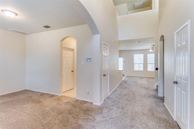 hall featuring light colored carpet