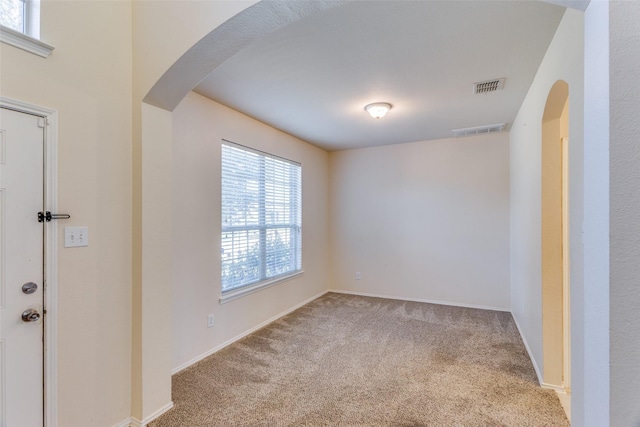 unfurnished room featuring light colored carpet