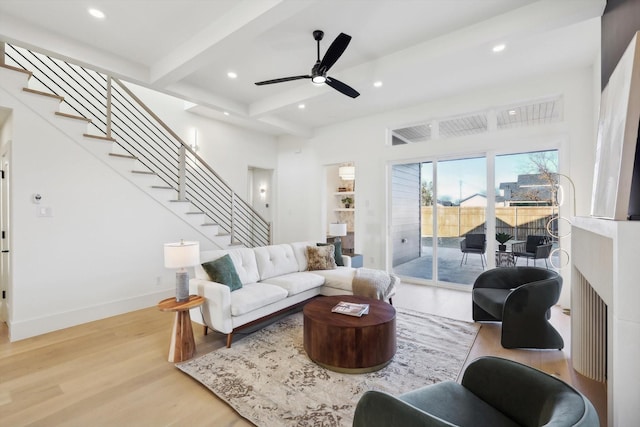 living room with beamed ceiling, ceiling fan, and wood-type flooring