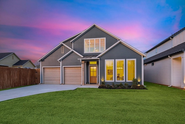 view of front of property with a yard and a garage