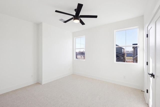 spare room with light carpet and ceiling fan