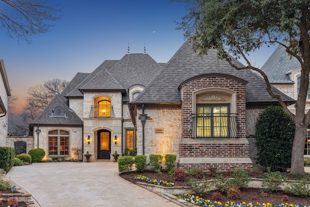 french country home with a balcony