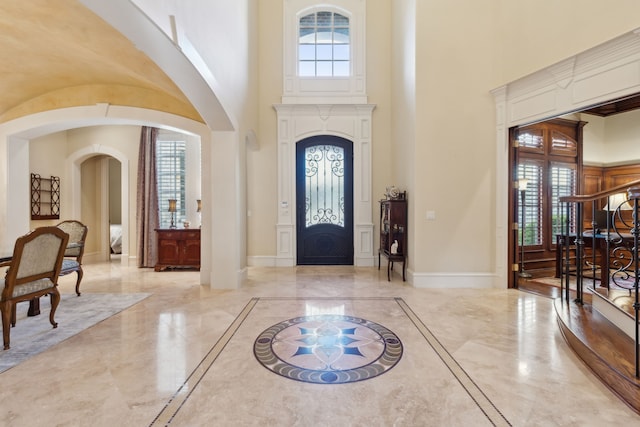 entryway with a towering ceiling and a wealth of natural light