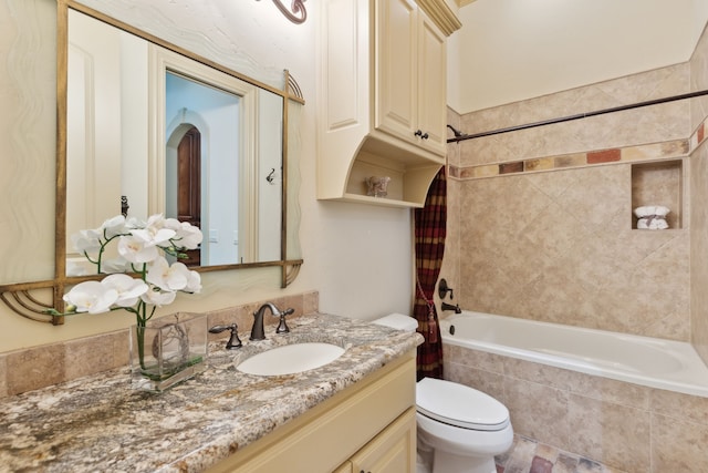 full bathroom with shower / bathtub combination with curtain, vanity, and toilet