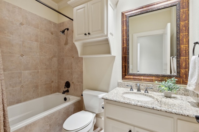 full bathroom featuring crown molding, toilet, vanity, and tiled shower / bath