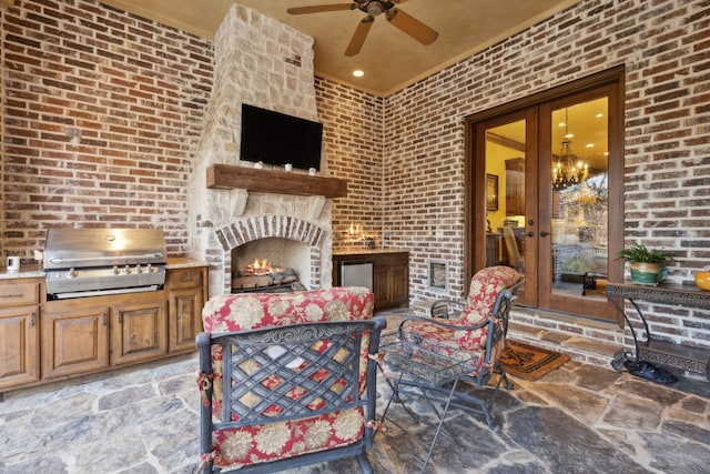 view of patio with ceiling fan, french doors, an outdoor kitchen, a grill, and an outdoor stone fireplace