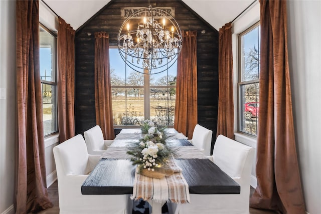 dining room featuring vaulted ceiling and a notable chandelier