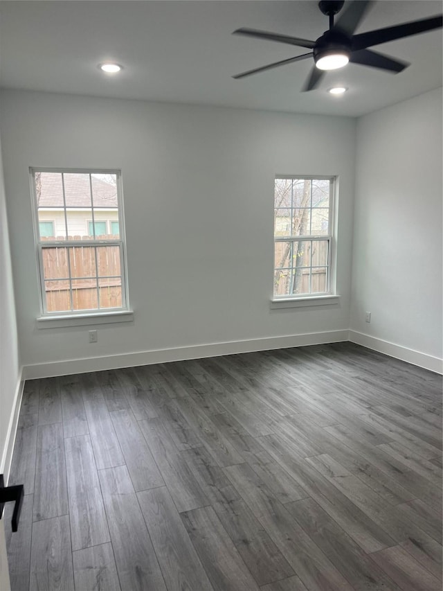 empty room featuring ceiling fan and dark wood-type flooring