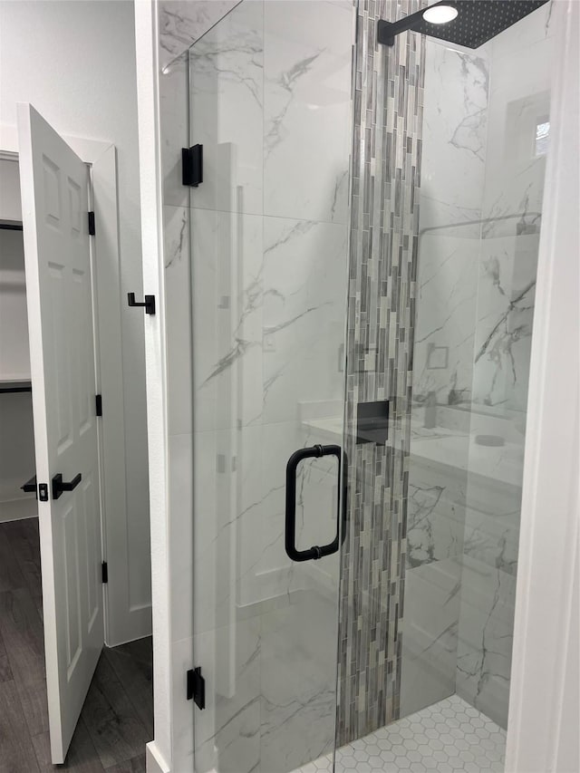 bathroom featuring a shower with shower door