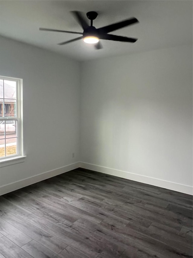 empty room featuring ceiling fan and dark hardwood / wood-style flooring