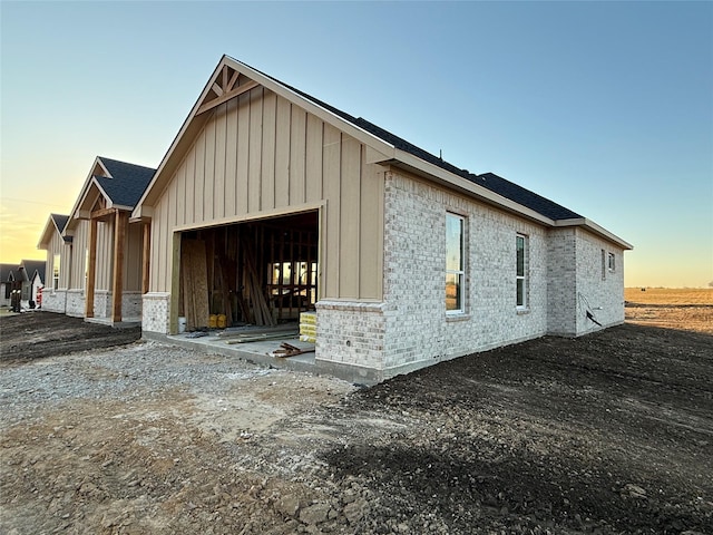 property exterior at dusk featuring an outdoor structure