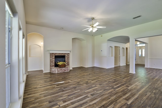 unfurnished living room featuring ceiling fan, dark hardwood / wood-style flooring, and a fireplace