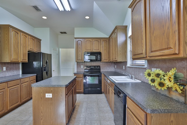 kitchen with sink, a kitchen island, tasteful backsplash, light tile patterned flooring, and black appliances