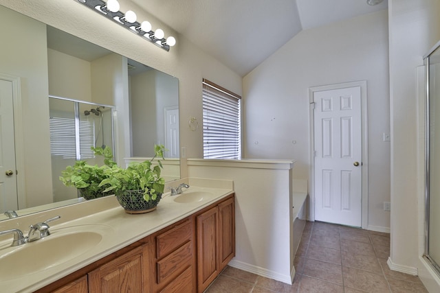 bathroom with tile patterned floors, vanity, vaulted ceiling, and independent shower and bath