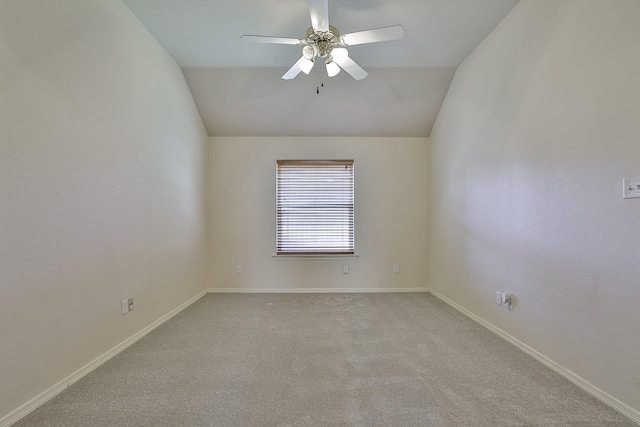 carpeted empty room with ceiling fan and lofted ceiling