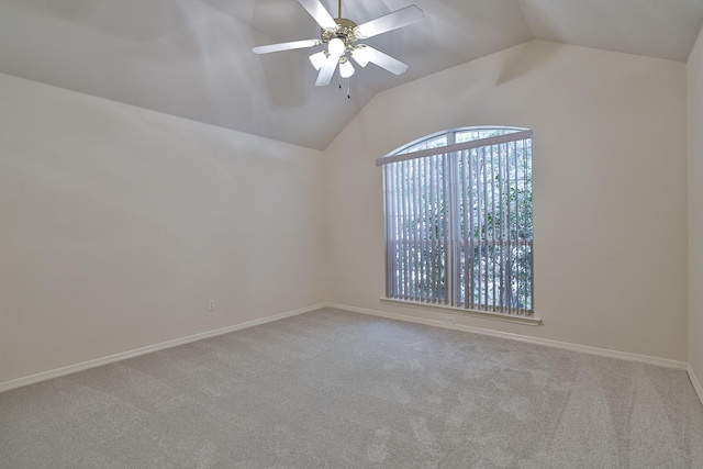 carpeted empty room with ceiling fan and vaulted ceiling