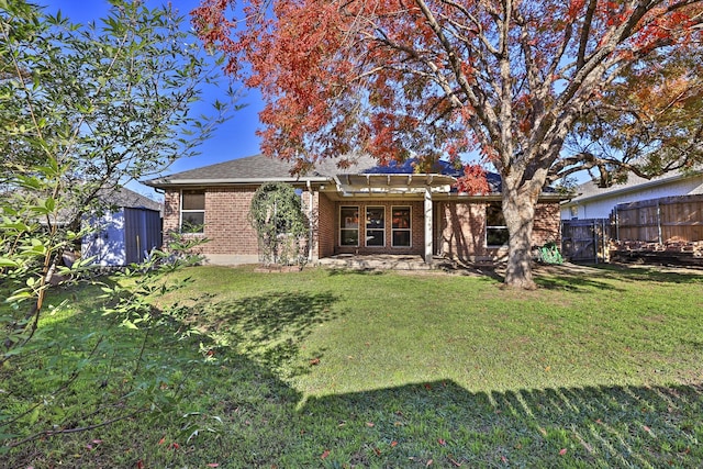 rear view of property featuring a pergola and a yard