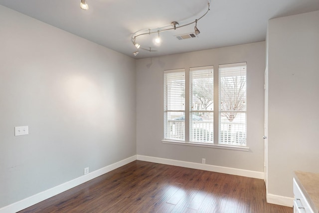 empty room with dark hardwood / wood-style floors