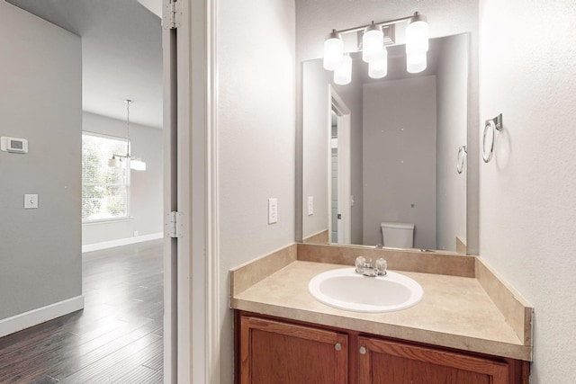 bathroom with vanity, hardwood / wood-style flooring, and toilet