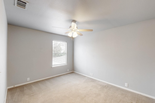 spare room featuring light carpet