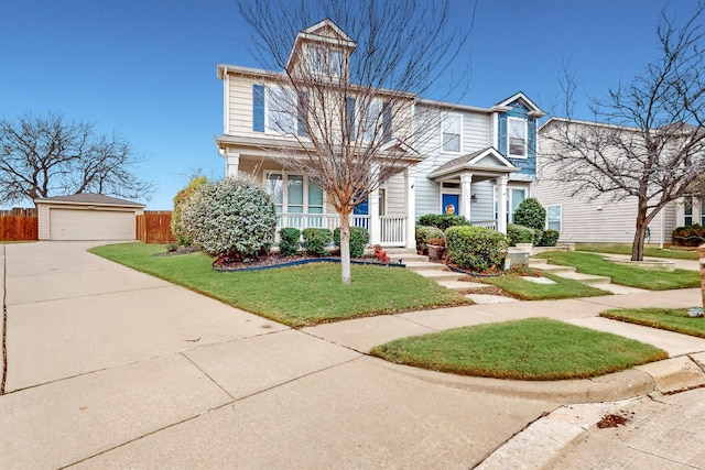 view of front of home featuring a front lawn, covered porch, an outdoor structure, and a garage