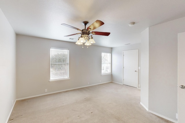 unfurnished room featuring light colored carpet and ceiling fan