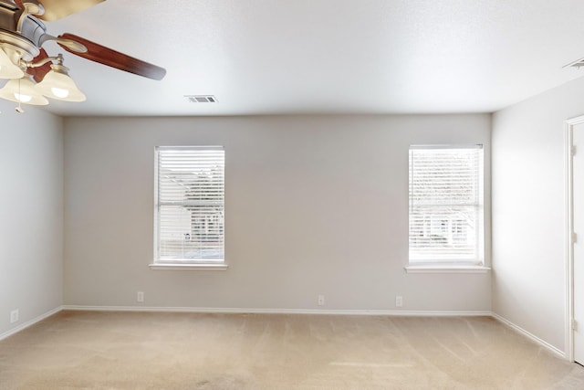 carpeted empty room featuring ceiling fan