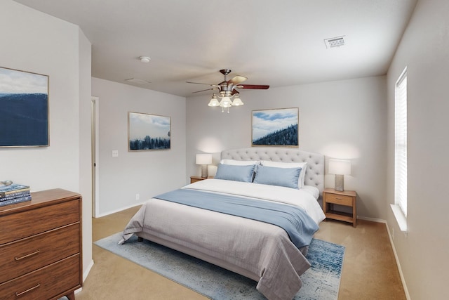 bedroom with ceiling fan and light carpet