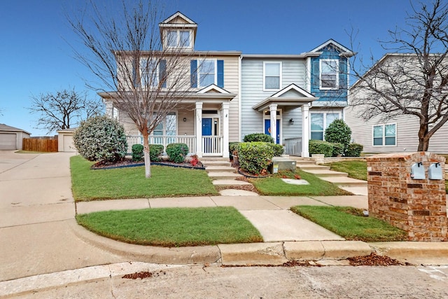 view of front of home featuring a front yard, a garage, and an outdoor structure