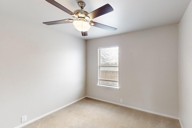 spare room featuring light carpet and ceiling fan