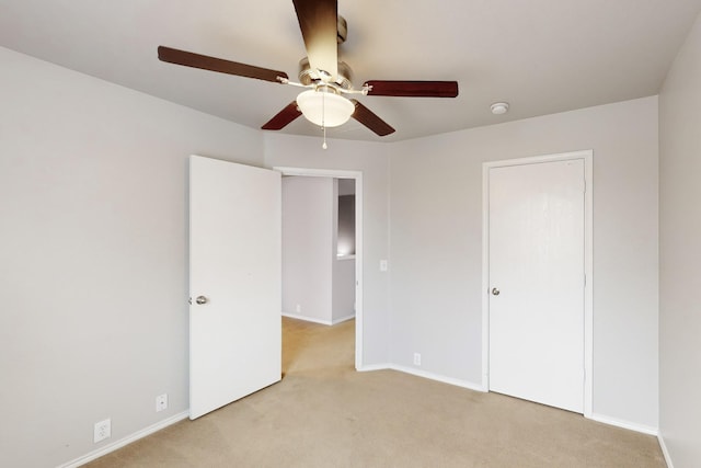 unfurnished bedroom with light carpet and ceiling fan