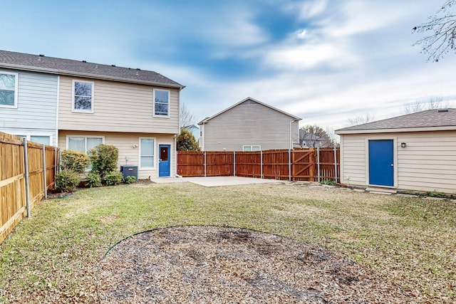 back of house featuring a lawn, a patio area, and central AC unit