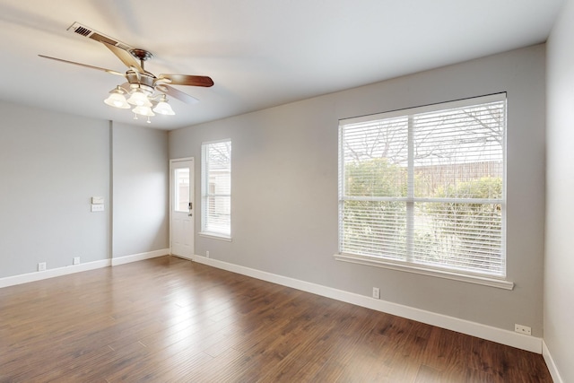 spare room featuring a wealth of natural light, ceiling fan, and hardwood / wood-style flooring