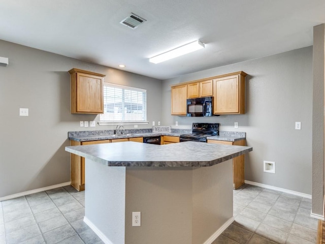 kitchen featuring sink, a center island, and black appliances