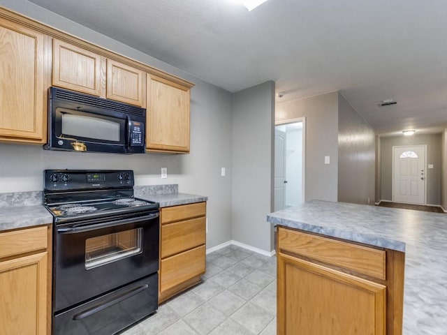 kitchen with light brown cabinets and black appliances