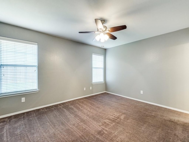 carpeted spare room with plenty of natural light and ceiling fan