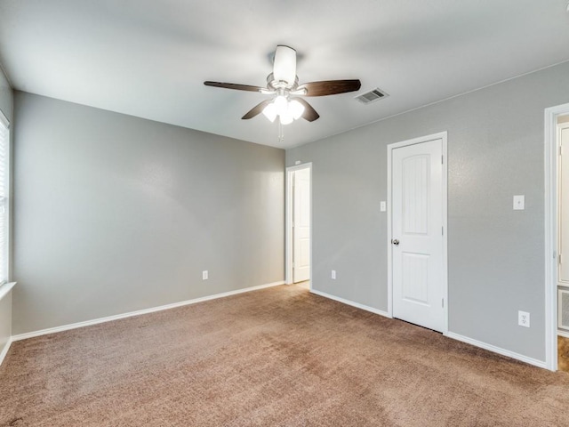 empty room with carpet floors and ceiling fan