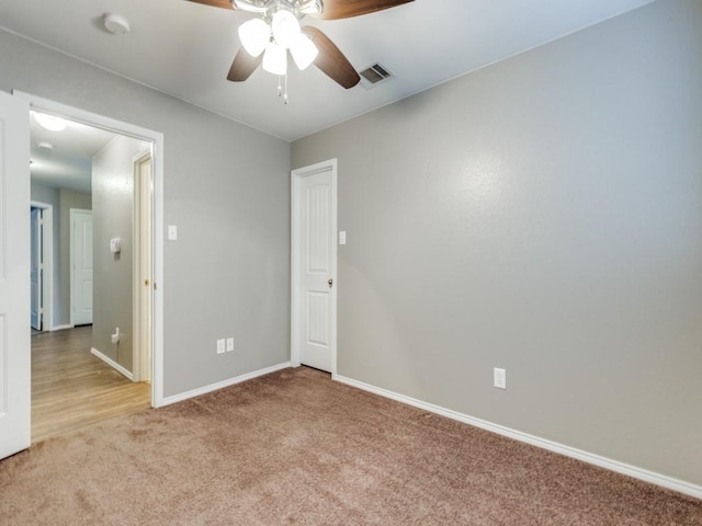 empty room with light carpet and ceiling fan