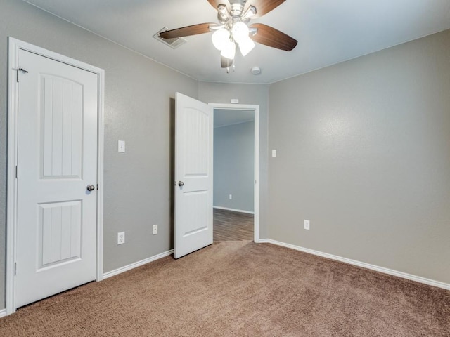 unfurnished bedroom featuring carpet flooring and ceiling fan