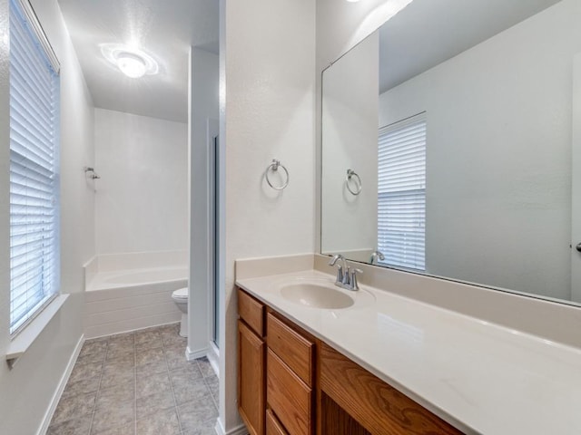 bathroom with tile patterned floors, vanity, a bath, and toilet