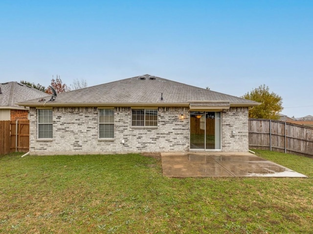 back of property featuring a patio area and a yard