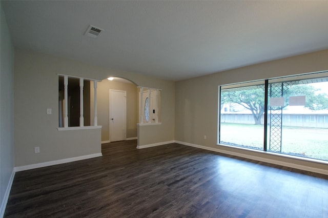 unfurnished room featuring dark wood-type flooring