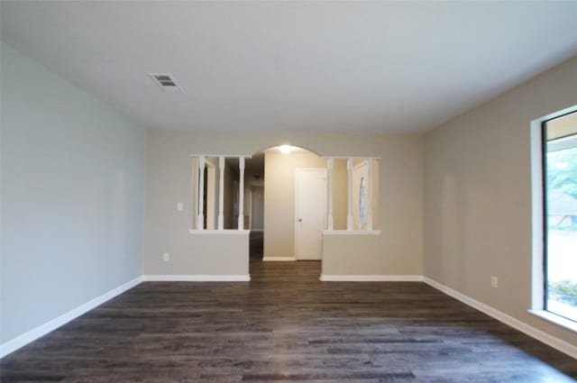 empty room with dark hardwood / wood-style floors