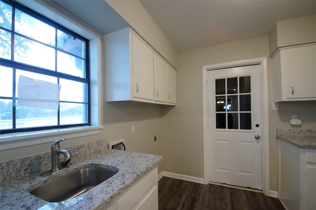 kitchen with dark wood-type flooring, white cabinetry, sink, and light stone counters